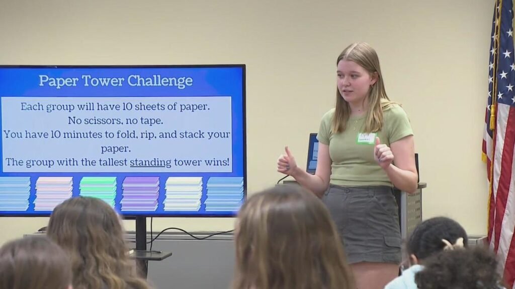 Girl is teaching students at summer camp