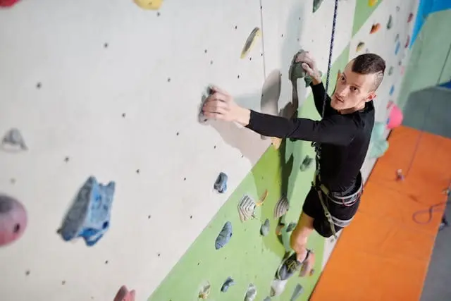 a man climbing rocks 