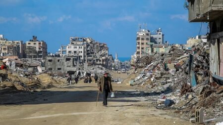 Civilians walking through the destructed buildings