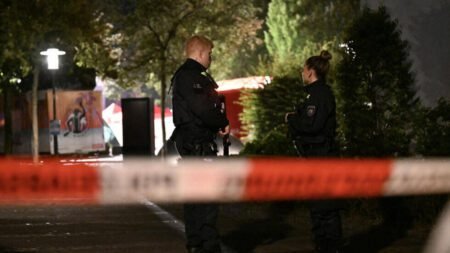 Police officers secure the scene of a knife attack in Germany