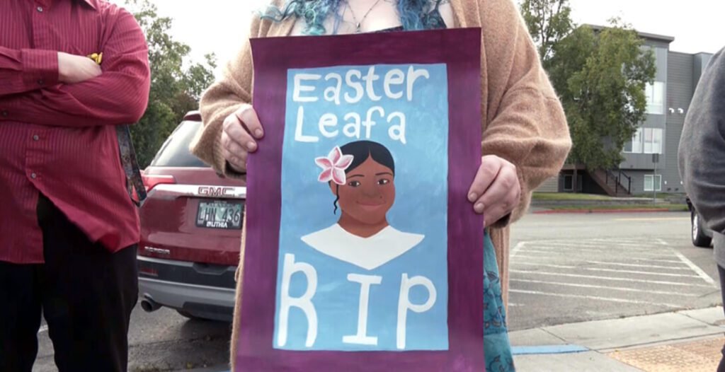 A Person Holding A Poster of Easter Leafa at Her Vigil