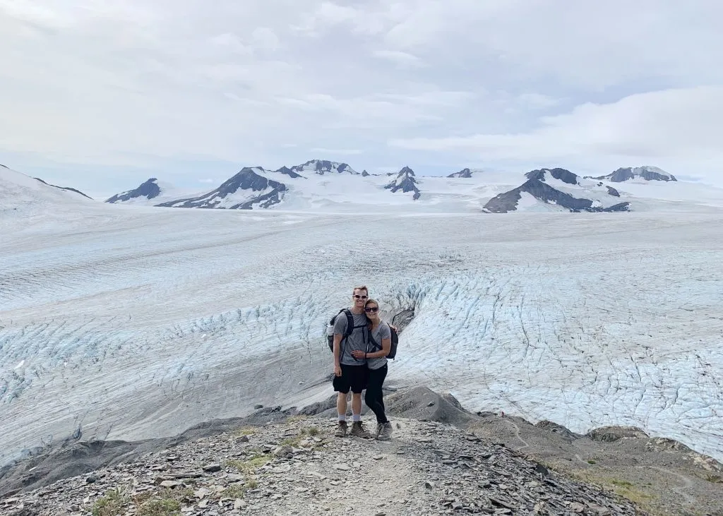 a couple is hiking Harding icefield trail in Alaska