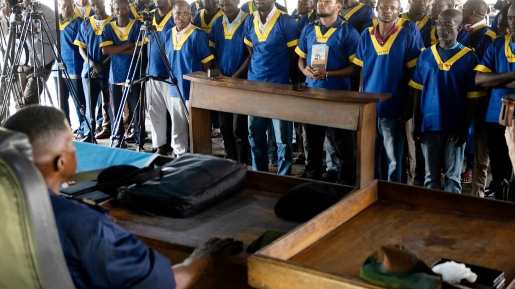 American Marcel Malanga stands with others during a court verdict