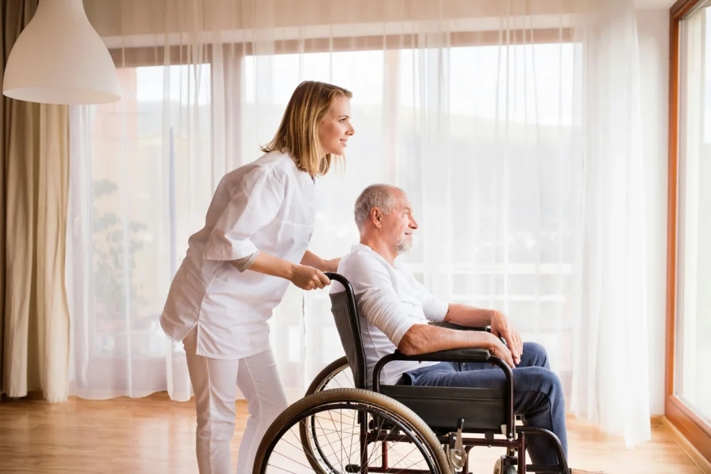 WOMEN helping an old man on wheel chair