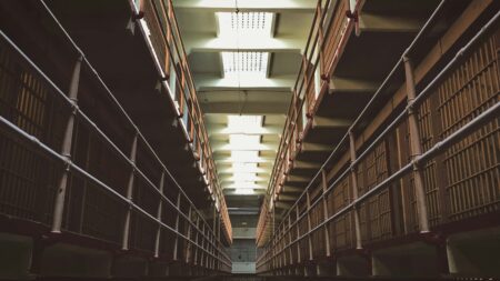 Privacy Concerns Rise After Alaska Inmates Health Data Breach Involving Fake Diagnoses A long, narrow corridor inside a prison