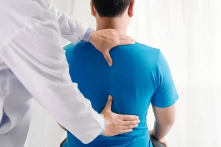 From Clicks to Clients: Turning Social Media Followers into Loyal Chiropractic Patients Doctor physiotherapist doing healing treatment on man's back.