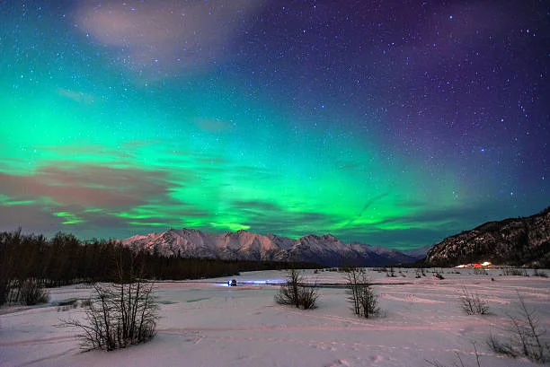 Beautiful green Northern light (Aurora Borealis) at Knik River in Alaska.