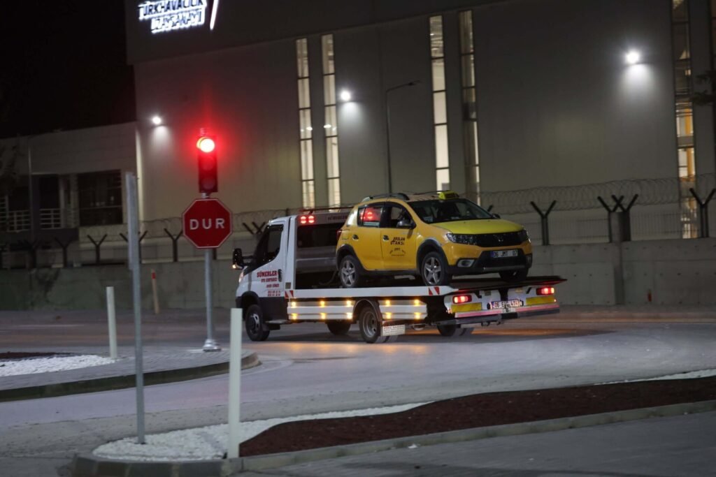 A truck removes a taxi cab that was used by suspects in a terrorist attack.