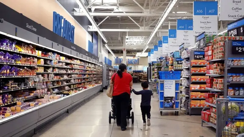 A women and a child walking inside a walmart store