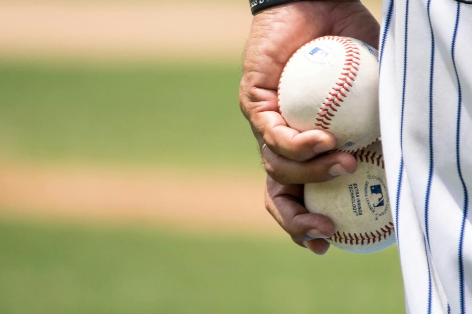 A player is holding two baseball balls