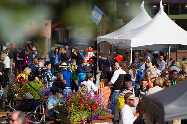 A crowd of people having a good time at an outdoor festival.