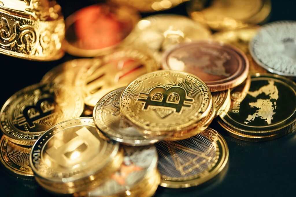 A pile of gold colored Bitcoins.