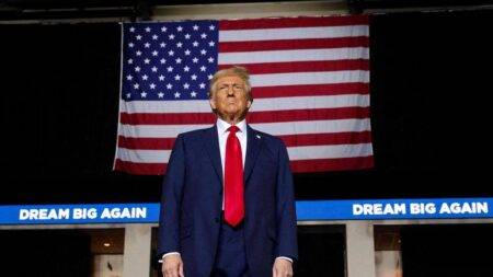 The President-elect of US, Donald Trump standing in front of the American flag.