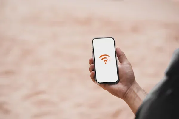 Cybersecurity Tips For iOS And Android Mobile Devices a person holding phone in his hand