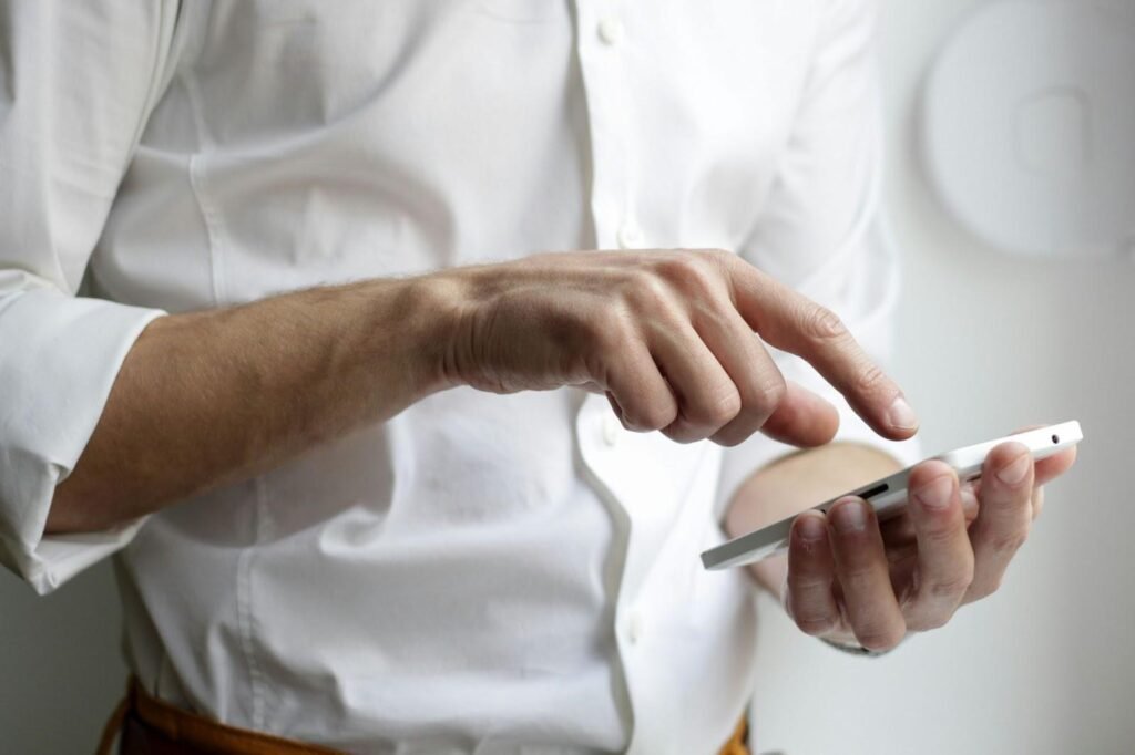 person-holding-white-android-smartphone-in-white-shirt