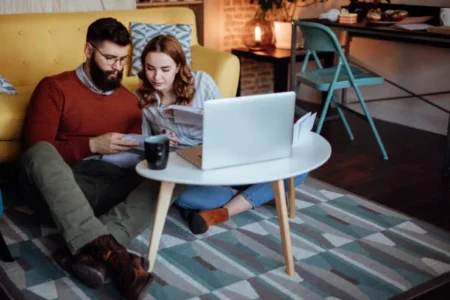 Young couple looking trough mail expecting new orders