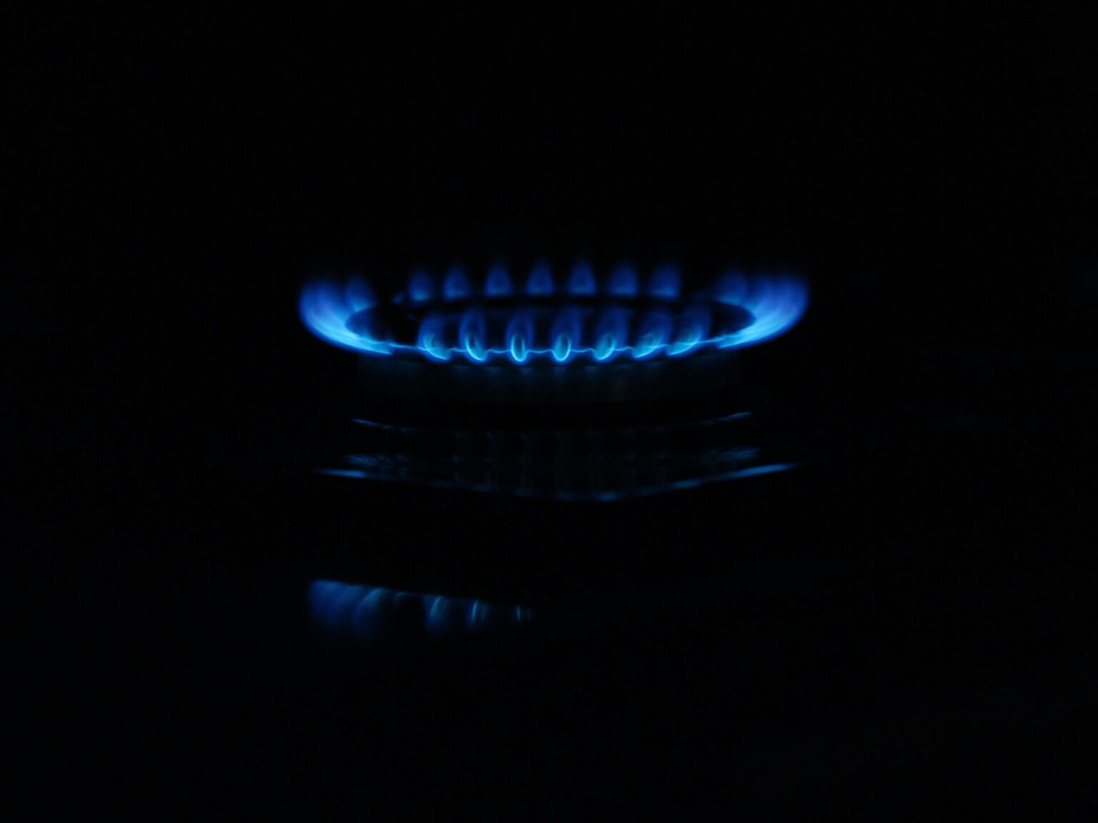 Anchorage Faces Loming Natural Gas Shortage Crisis A gas stove with blue flames.
