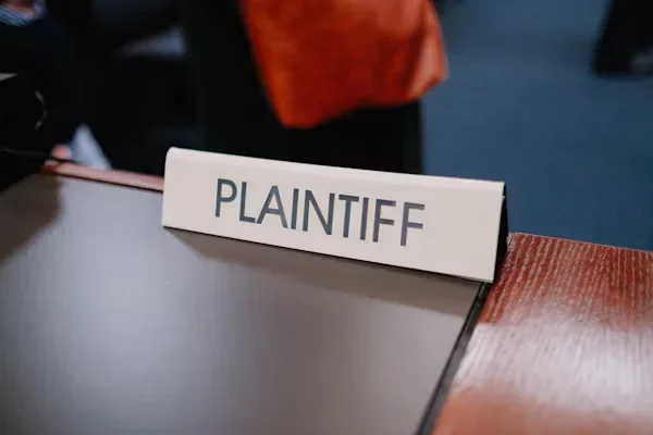 Why Should You Hire a PI Lawyer When You're Not at Fault? PLAINTIFF written on table