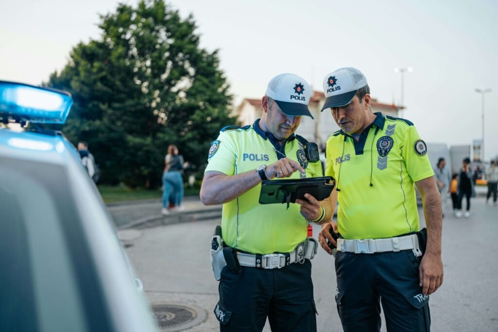 Two Police Officers standing together.