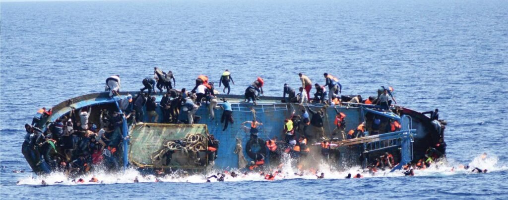 A refugee boat sinking in the ocean.