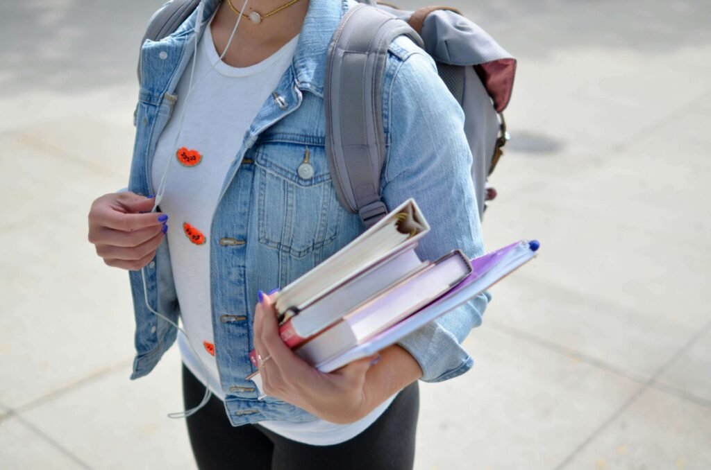 A school girl holding books.