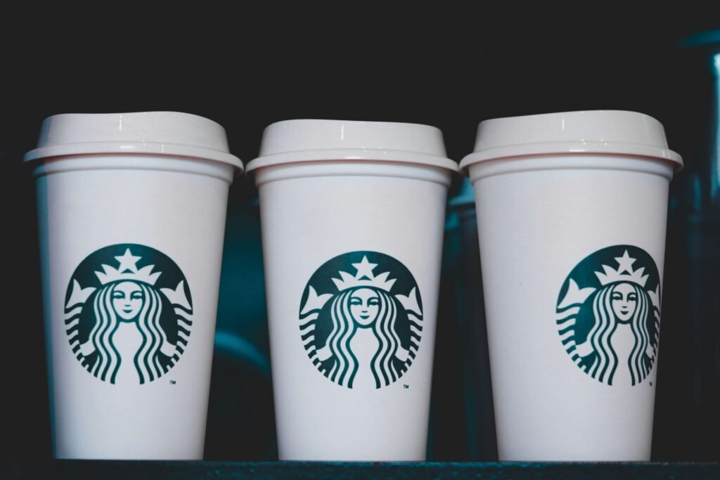 Three Starbucks cups on a table.