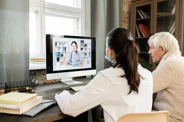 Discovering Hybrid Therapy: A Balanced Approach to Mental Wellness a man and woman sitting in front of laptop