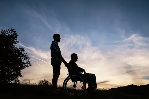 a man holding wheel chair