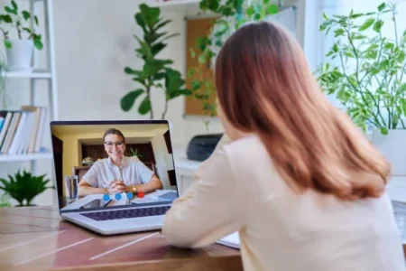 a woman having online therapy with psychotherapist