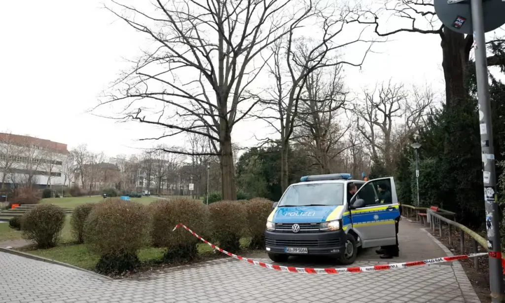 A police van near the crime scene where a person stabbed people in Germany.