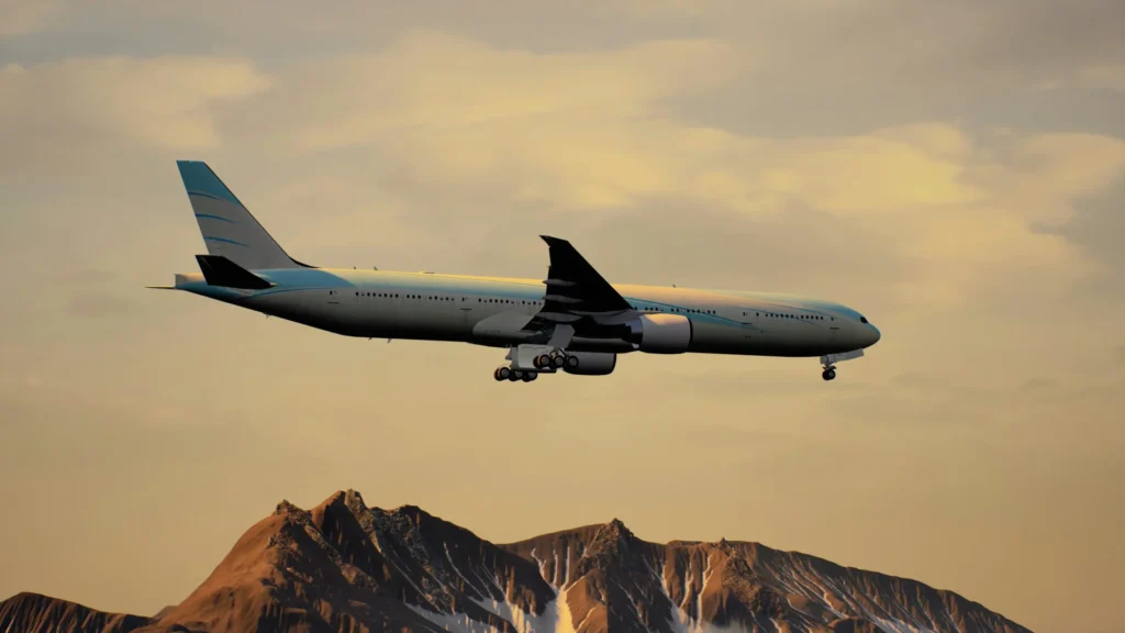 An Airplane in the sky over the mountains.