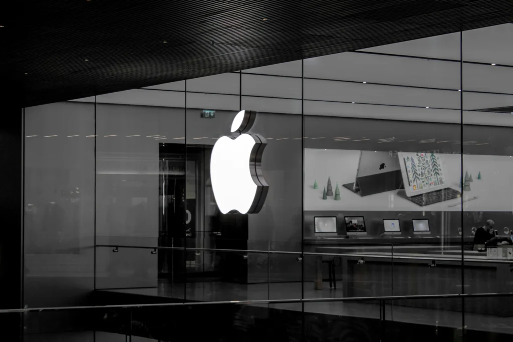 White Apple Logo on a glass wall.