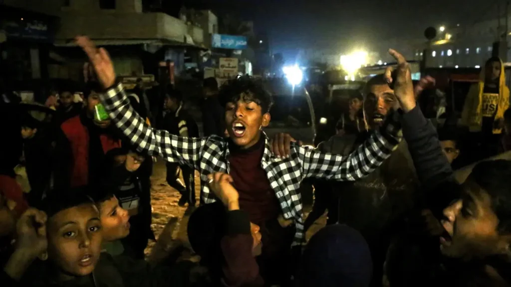 Palestinians celebrate the announcement of a deal between Hamas and Israel.