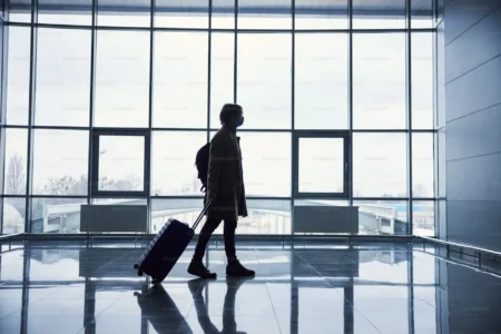 7 Things Everyone Does When Arriving at the Airport man with a lagguage bag