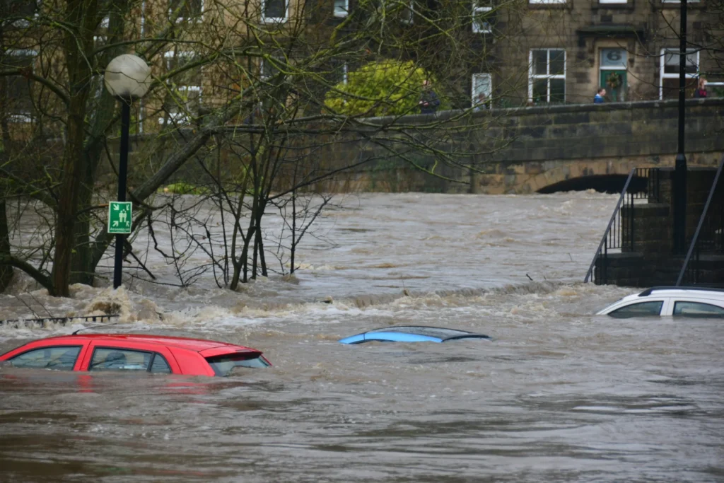 A view after a flood with cars submerged in the water.