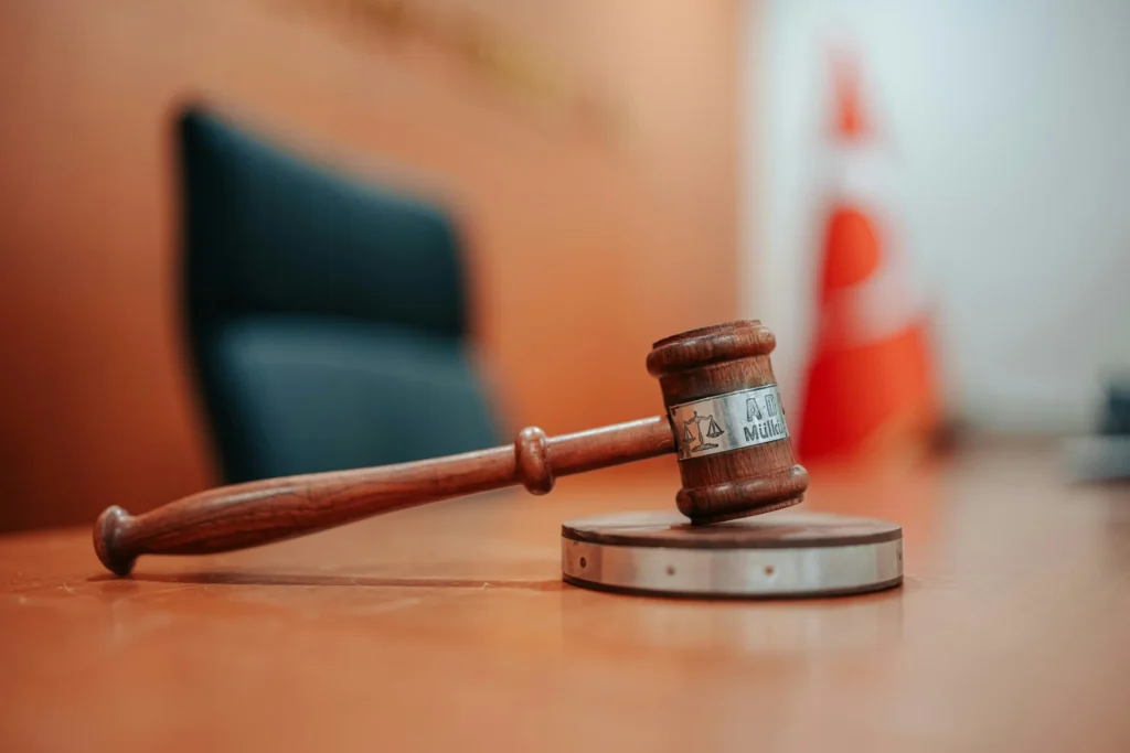 A wooden gavel sitting on top of a table.