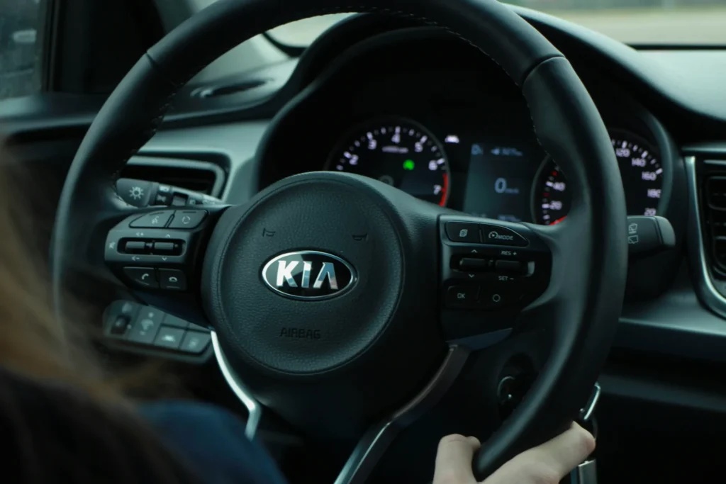 A steering wheel with Kia written on it.