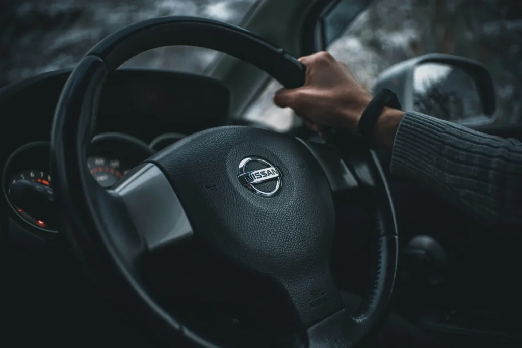 A steering wheel with Nissan´s logo.