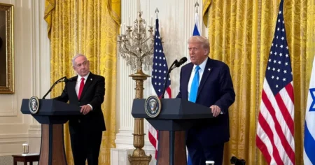 Trump Sanctions ICC Over Netanyahu’s Arrest Warrant and Gaza Plan US President Donald Trump and Israeli Prime Minister Benjamin Netanyahu standing together.