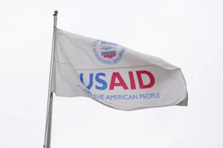 A Federal Judge Halted Trump’s USAID Worker Suspension Plan A flag with USAID written on it.