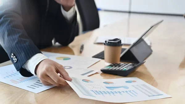 Risk Management and Compliance: How CPAs Safeguard Your Business a man holding a paper in his hand
