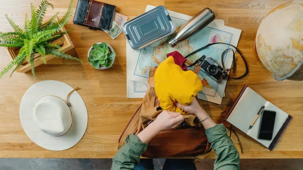 a person packing stuff for trip