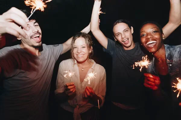 How to Carry Your Traditions With You When You Move Overseas A group of people celebrating with sparkles
