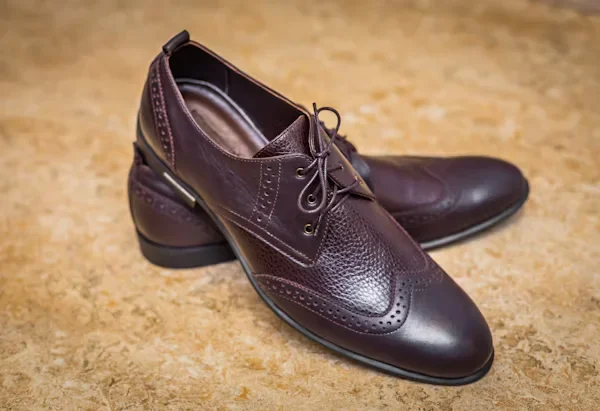 10 Expert Tips for Buying Durable Men's Leather Sandals Dark brown leather shoes on floor