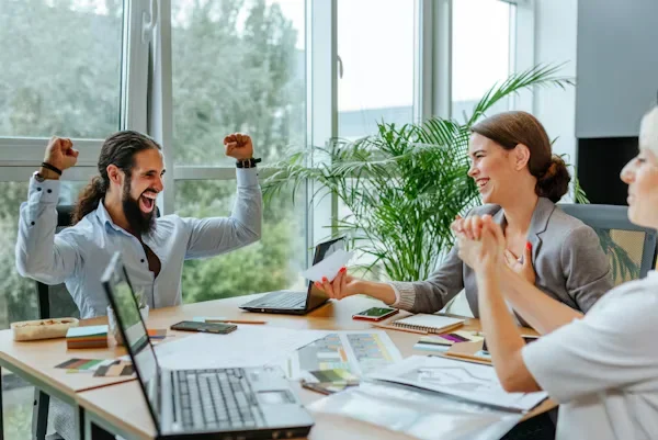 10 Employee Recognition Ideas That Drive Culture a happy man sitting next to a woman