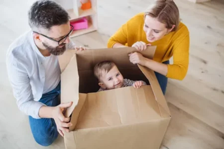 a happy parents with their child in the box