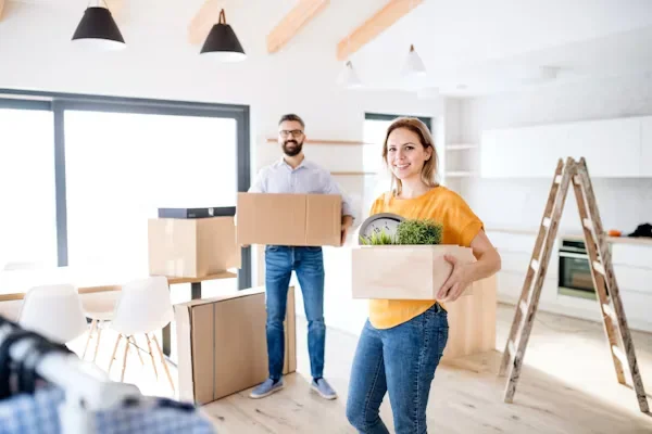 How to Carry Your Traditions With You When You Move Overseas a man and woman holding boxes in their hands