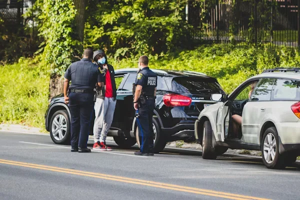 a man standing with police officers