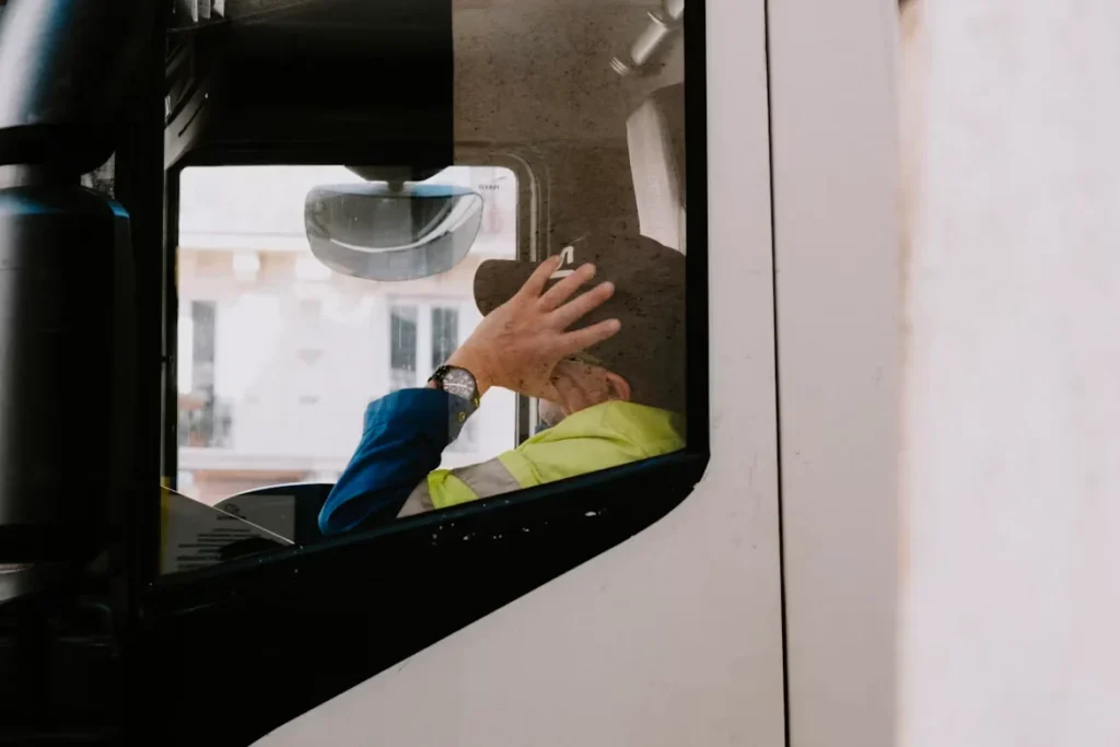 The Impact of Fatigue on Truck Drivers and How to Prevent It a person sleeping in truck