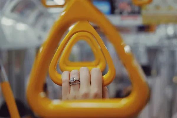 a woman holding bus handle